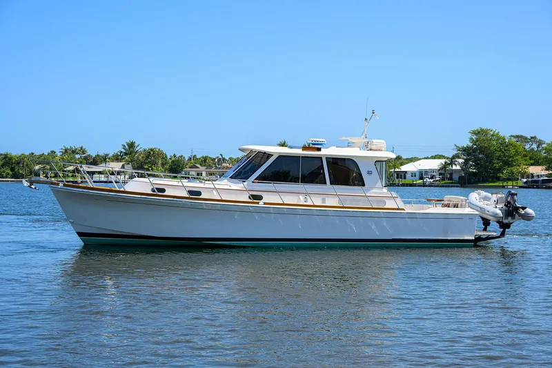Seabird Yacht Photos Pics 2014 Grand Banks 46 Eastbay SX yacht on calm water, side view.