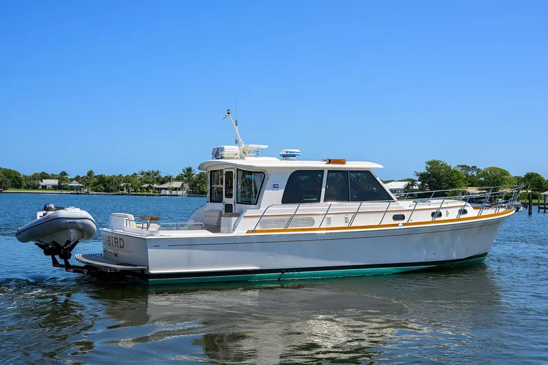 Seabird Yacht Photos Pics 2014 Grand Banks 46 Eastbay SX yacht on calm water, clear sky background.