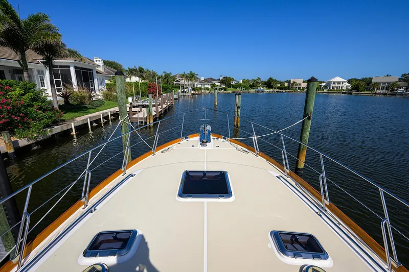 Seabird Yacht Photos Pics Bow view of 2014 Grand Banks 46 Eastbay SX yacht docked in a serene marina.