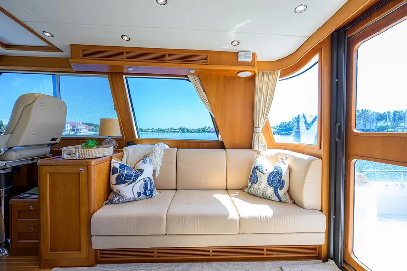 Seabird Yacht Photos Pics Luxurious interior of 2014 Grand Banks 46 Eastbay SX yacht with beige sofa and scenic windows.