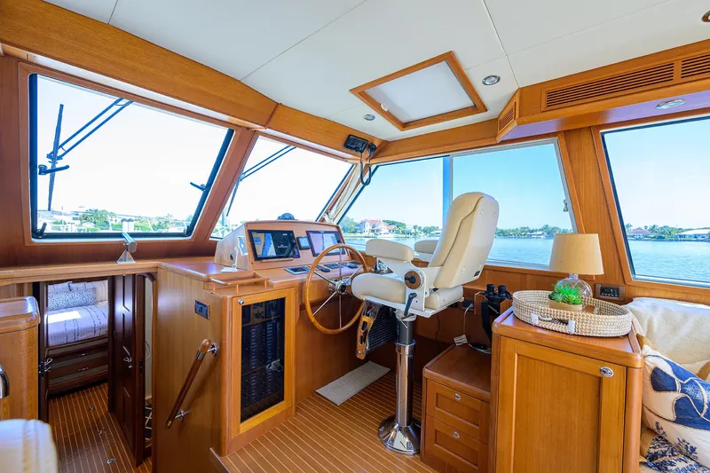 Seabird Yacht Photos Pics Interior of 2014 Grand Banks 46 Eastbay SX yacht, featuring helm and luxurious seating.