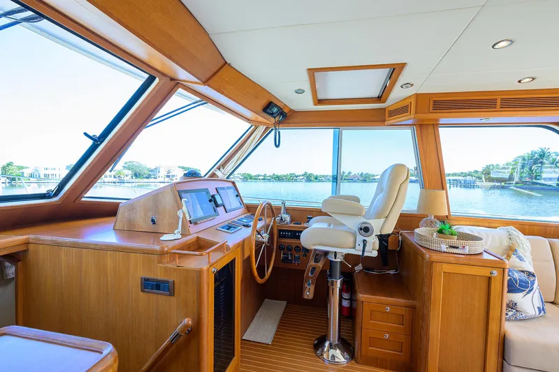 Seabird Yacht Photos Pics 2014 Grand Banks 46 Eastbay SX yacht interior with helm, wooden finish, and panoramic windows.