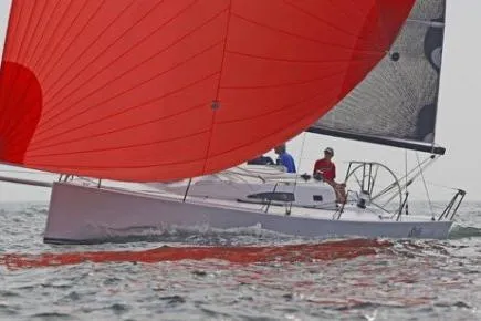 Elvis Yacht Photos Pics 2015 J Boats J 111 sailing with vibrant red spinnaker on open water.