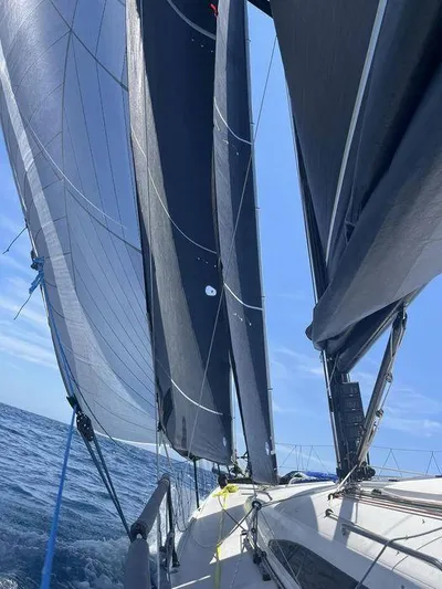 Ceilidh Yacht Photos Pics Sailing on a 2018 J Boats J/121 with full sails under a clear blue sky.