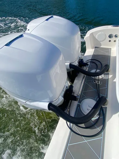  Yacht Photos Pics 2022 Fountain 34 Tournament Edition boat with dual outboard engines on water.