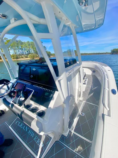  Yacht Photos Pics 2022 Fountain 34 Tournament Edition boat on a serene lake.