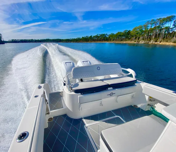  Yacht Photos Pics 2022 Fountain 34 Tournament Edition boat cruising on a serene lake.