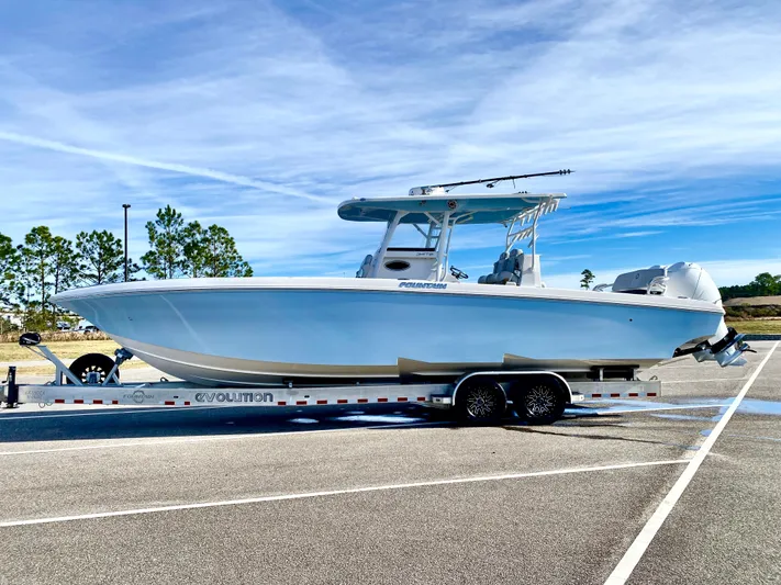  Yacht Photos Pics 2022 Fountain 34 Tournament Edition boat on a trailer in a parking lot.