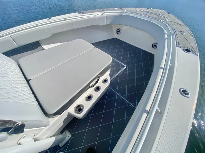  Yacht Photos Pics 2022 Fountain 34 Tournament Edition boat interior with cushioned seating and rod holders.
