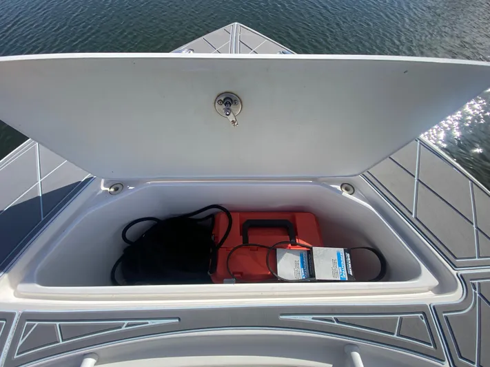  Yacht Photos Pics Open storage compartment on 2022 Fountain 34 Tournament Edition boat, containing safety equipment.