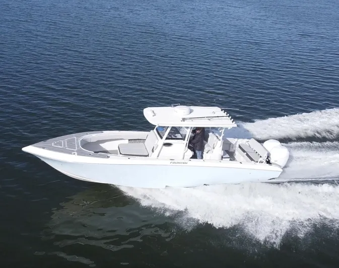  Yacht Photos Pics 2022 Fountain 34 Tournament Edition boat cruising on open water.