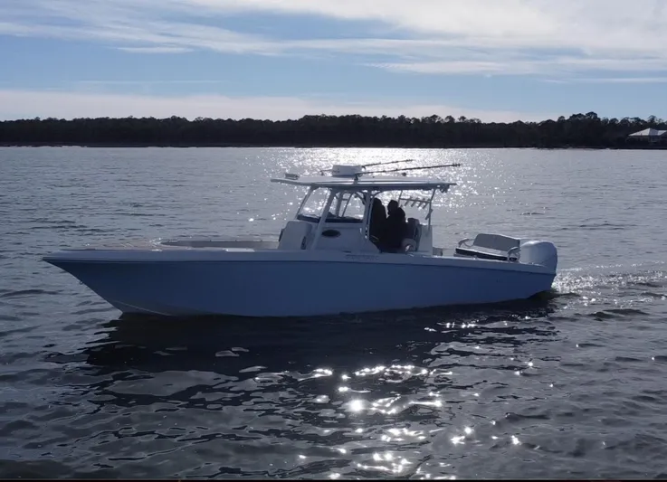  Yacht Photos Pics 2022 Fountain 34 Tournament Edition boat cruising on a calm lake.