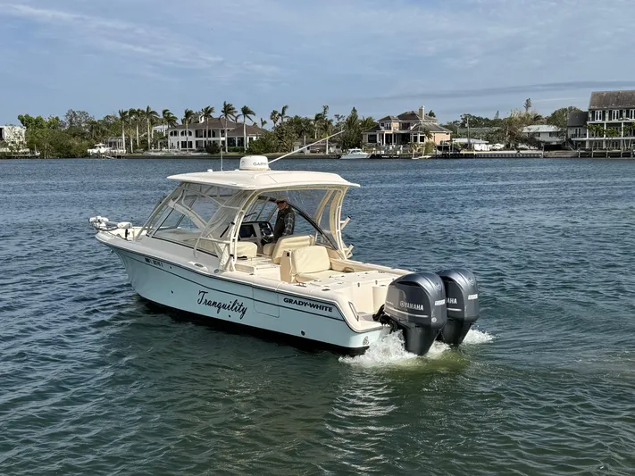 Tranquility Yacht Photos Pics 2021 Grady-White Freedom 285 boat cruising on a calm waterway.