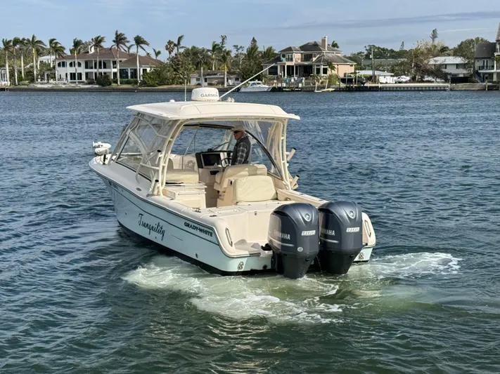 Tranquility Yacht Photos Pics 2021 Grady-White Freedom 285 boat cruising on a scenic waterway.