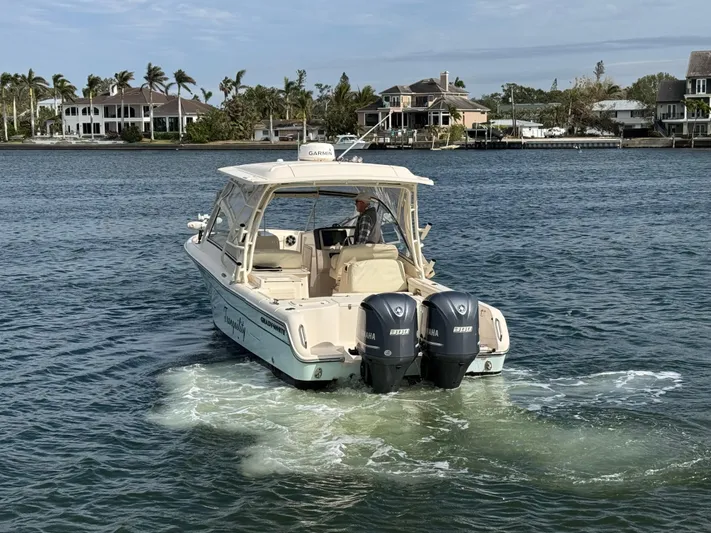 Tranquility Yacht Photos Pics 2021 Grady-White Freedom 285 boat cruising on a calm waterway.