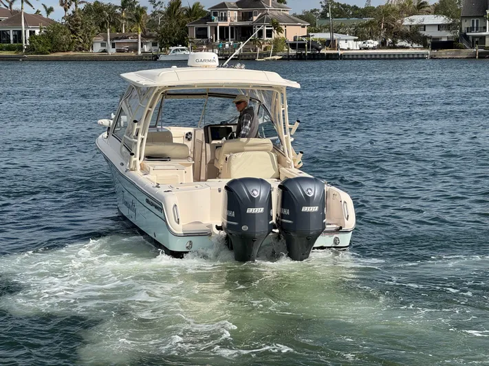 Tranquility Yacht Photos Pics 2021 Grady-White Freedom 285 boat cruising on a scenic waterway.