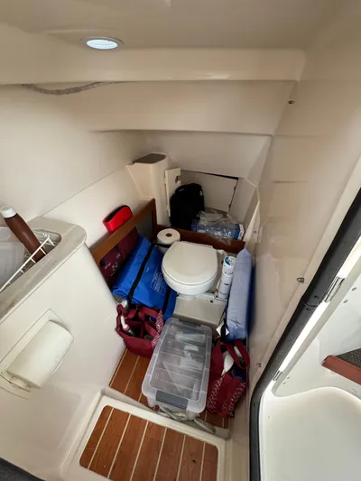 Tranquility Yacht Photos Pics 2021 Grady-White Freedom 285 boat interior with storage and toilet area.