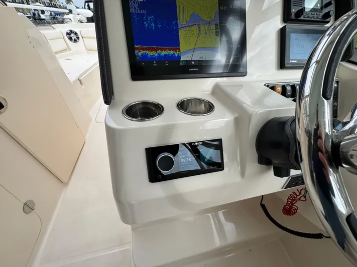 Tranquility Yacht Photos Pics 2021 Grady-White Freedom 285 boat dashboard with navigation display and controls.