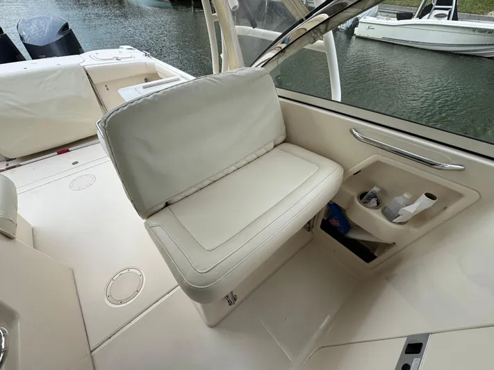 Tranquility Yacht Photos Pics 2021 Grady-White Freedom 285 boat interior with cushioned seating and storage compartments.