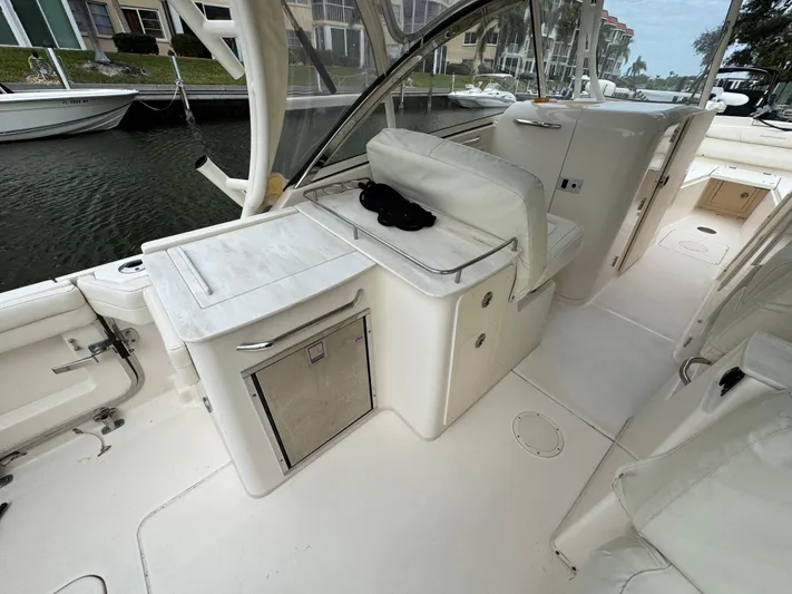 Tranquility Yacht Photos Pics 2021 Grady-White Freedom 285 boat interior with seating and storage, docked by waterfront homes.