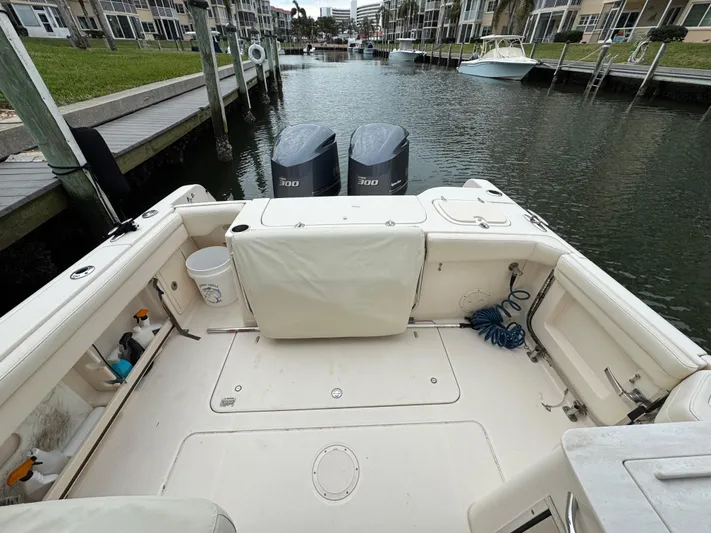 Tranquility Yacht Photos Pics 2021 Grady-White Freedom 285 boat with twin engines docked in a canal.