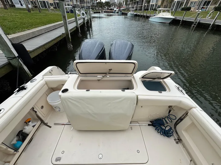 Tranquility Yacht Photos Pics 2021 Grady-White Freedom 285 boat with open storage compartments, docked in a marina.