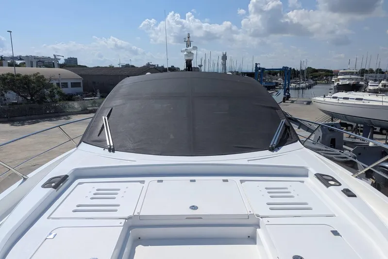  Yacht Photos Pics 2022 Sunseeker Predator 55 EVO yacht docked at marina under blue sky.