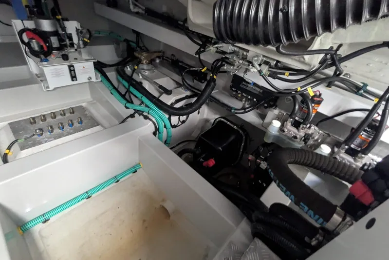  Yacht Photos Pics Engine room of 2022 Sunseeker Predator 55 EVO, showcasing complex wiring and mechanical components.