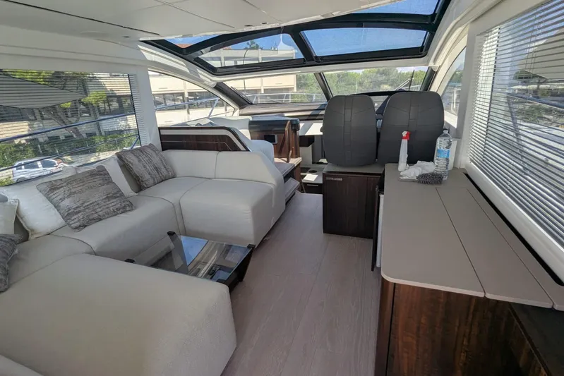  Yacht Photos Pics Luxurious interior of 2022 Sunseeker Predator 55 EVO yacht with modern seating and panoramic windows.