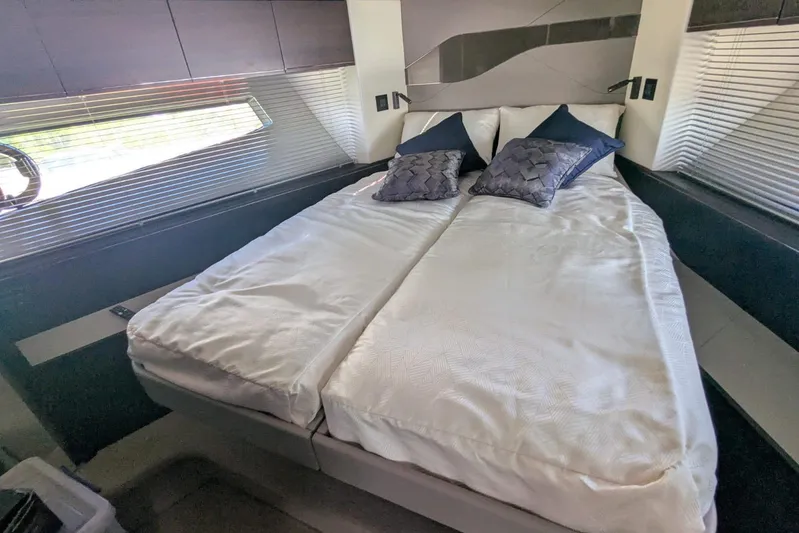  Yacht Photos Pics Luxurious bedroom interior of 2022 Sunseeker Predator 55 EVO yacht with elegant bedding.