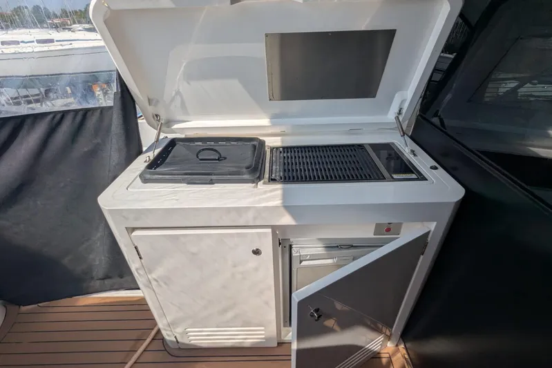  Yacht Photos Pics Outdoor kitchen on 2022 Sunseeker Predator 55 EVO yacht with grill and storage.