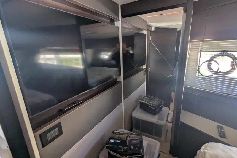  Yacht Photos Pics Interior of 2022 Sunseeker Predator 55 EVO yacht with modern TV and sleek design.