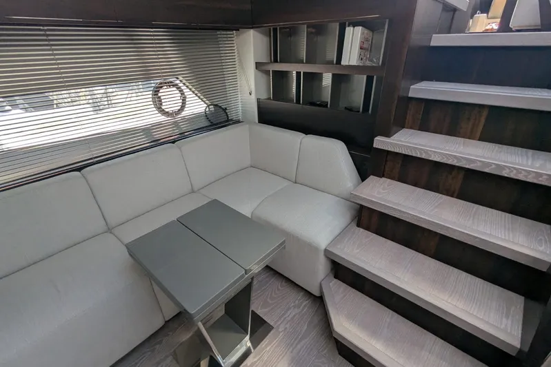  Yacht Photos Pics Luxurious interior of 2022 Sunseeker Predator 55 EVO yacht with modern seating and stairs.