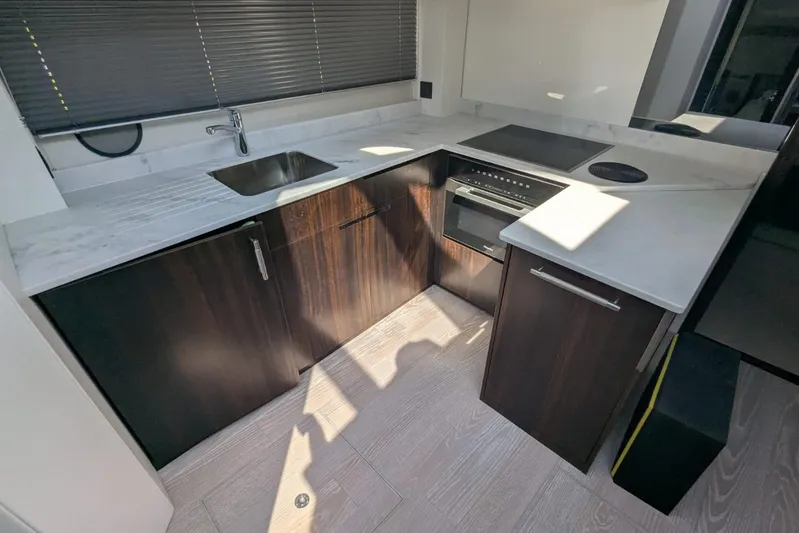  Yacht Photos Pics Modern kitchen interior of 2022 Sunseeker Predator 55 EVO yacht with sleek countertops.