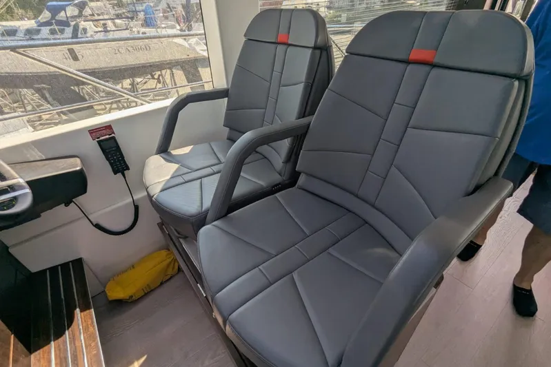  Yacht Photos Pics Luxury seating inside 2022 Sunseeker Predator 55 EVO yacht, featuring sleek gray upholstery.