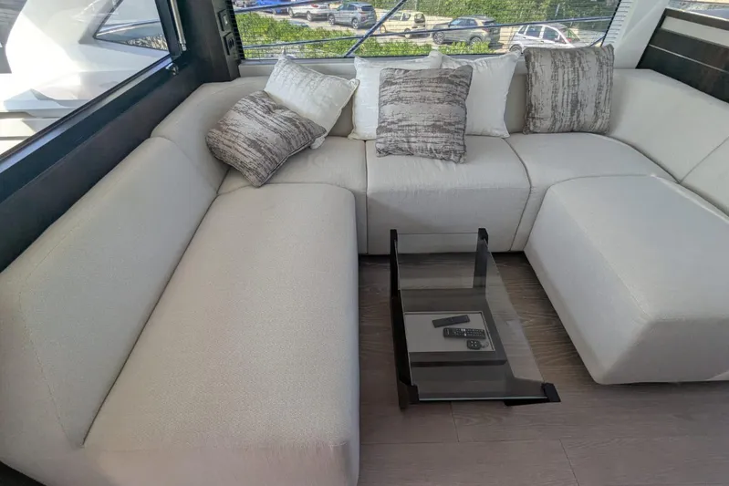  Yacht Photos Pics Luxurious interior of 2022 Sunseeker Predator 55 EVO yacht with plush seating and modern decor.