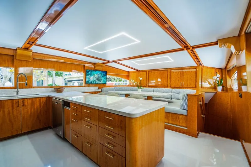Carpe Diem Yacht Photos Pics Luxurious kitchen and dining area on a 2001 Intermarine Raised Pilothouse yacht.