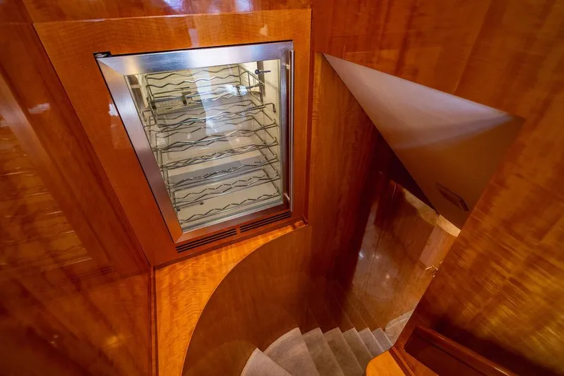 Carpe Diem Yacht Photos Pics Luxurious wooden staircase and wine cooler in 2001 Intermarine Raised Pilothouse yacht.