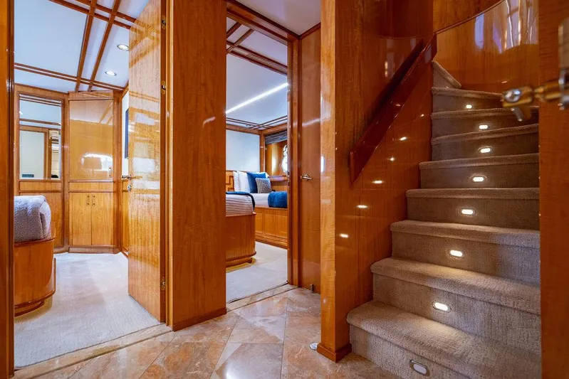 Carpe Diem Yacht Photos Pics Luxurious 2001 Intermarine Raised Pilothouse yacht interior with wooden finishes and carpeted stairs.