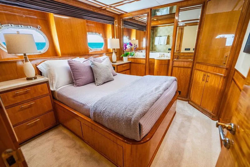 Carpe Diem Yacht Photos Pics Luxurious bedroom on a 2001 Intermarine Raised Pilothouse yacht with wooden interiors.
