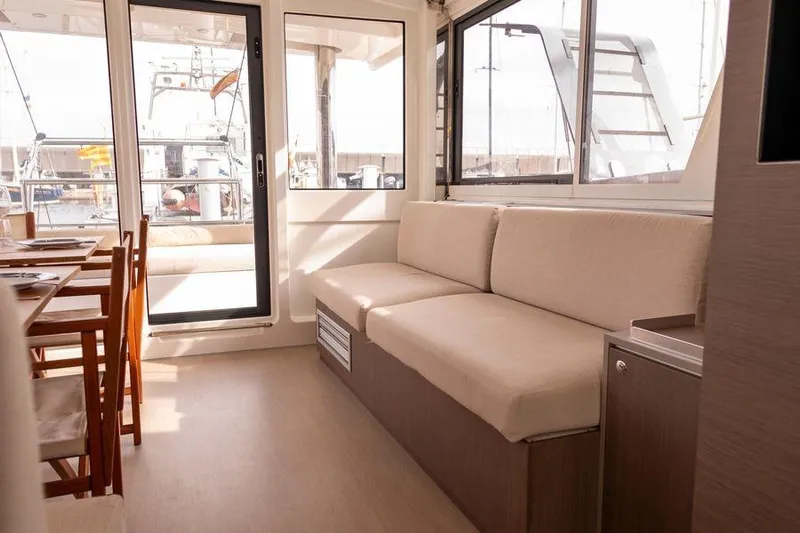Tatani Yacht Photos Pics Interior of 2021 Bali 4.8 catamaran with beige seating and dining area.