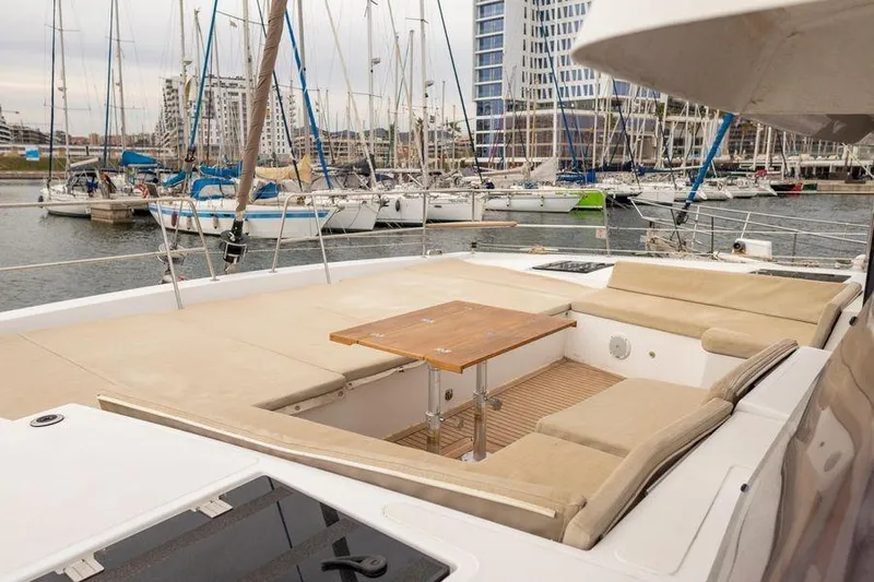 Tatani Yacht Photos Pics Luxurious 2021 Bali 4.8 catamaran with spacious deck seating in a marina setting.