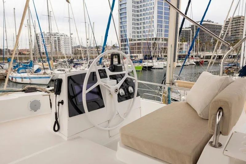 Tatani Yacht Photos Pics Steering area of a 2021 Bali 4.8 yacht in a marina setting.