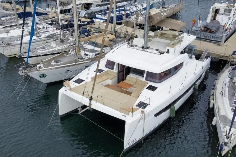 Tatani Yacht Photos Pics 2021 Bali 4.8 catamaran docked at marina, featuring spacious deck and modern design.
