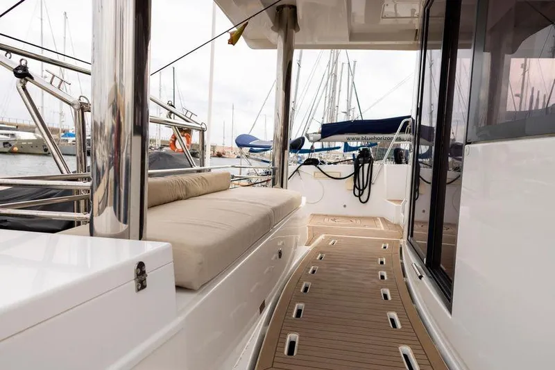 Tatani Yacht Photos Pics 2021 Bali 4.8 yacht deck with cushioned seating and sleek design in marina setting.