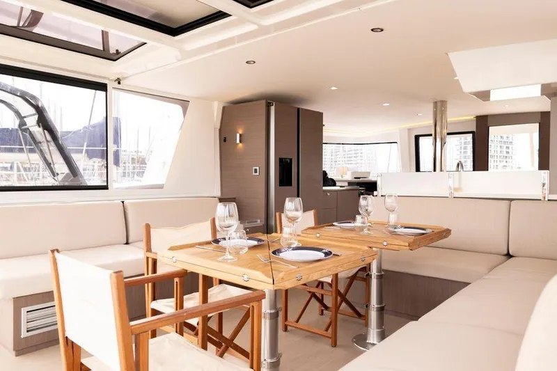 Tatani Yacht Photos Pics Luxurious interior of 2021 Bali 4.8 yacht with elegant dining area and modern furnishings.