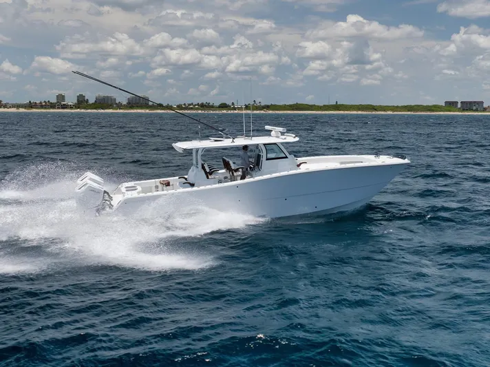 Sycorax Yacht Photos Pics 2024 Freeman 43 CC boat cruising on open water under a partly cloudy sky.