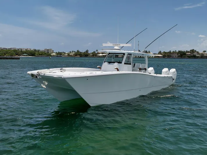 Sycorax Yacht Photos Pics 2024 Freeman 43 CC boat cruising on clear blue water under a sunny sky.
