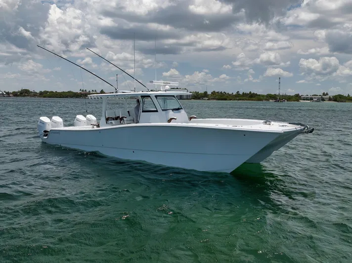 Sycorax Yacht Photos Pics 2024 Freeman 43 CC boat on water under cloudy sky.