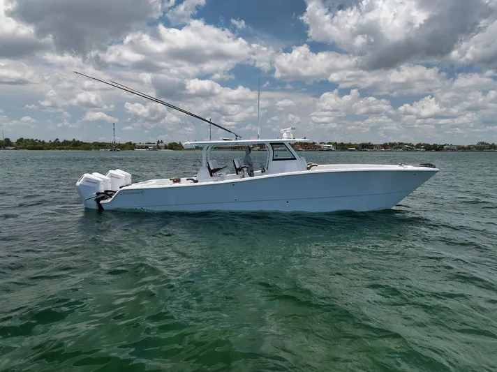 Sycorax Yacht Photos Pics 2024 Freeman 43 CC boat on water under cloudy sky.